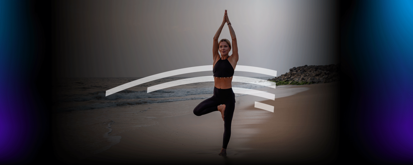 woman doing yoga pose on a beach