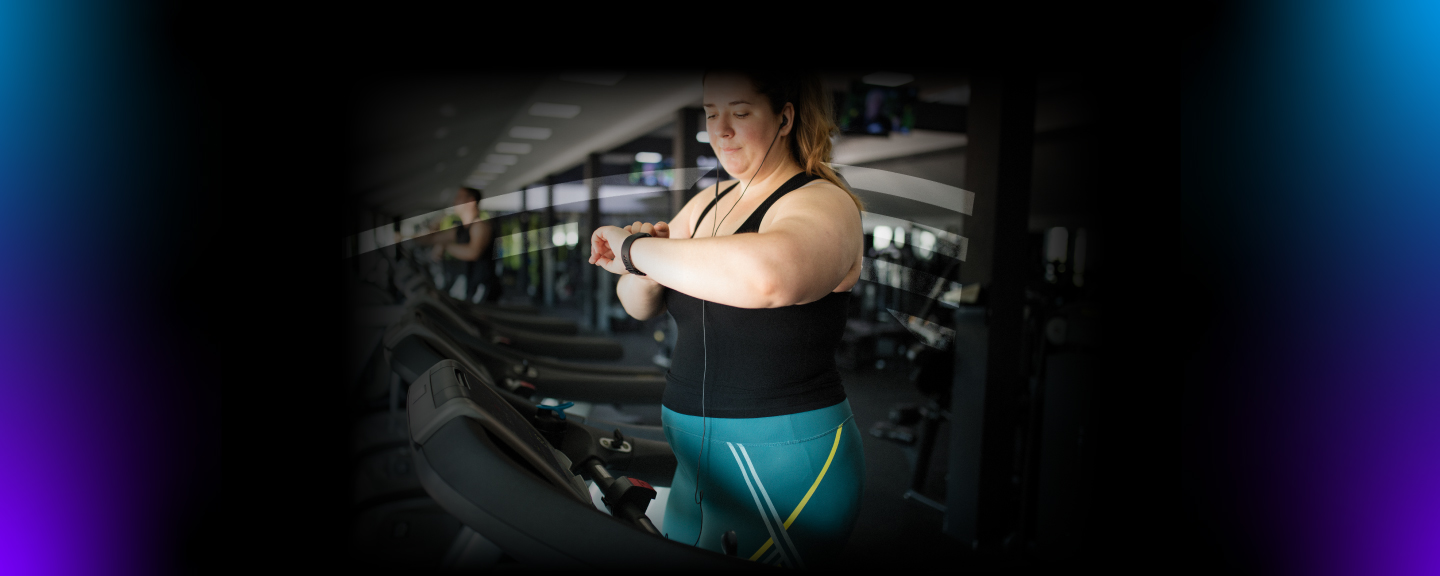 Woman on a treadmill checking her watch