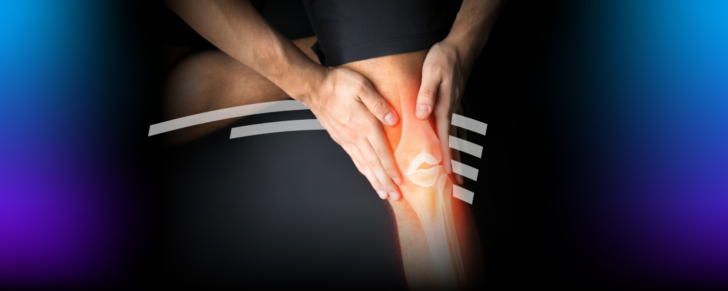 Person holding knee with ligaments