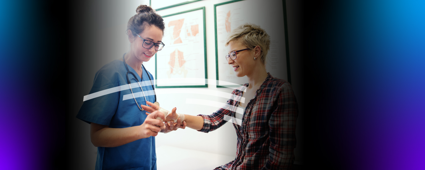 medical professional wrapping a patient's hand with gauze