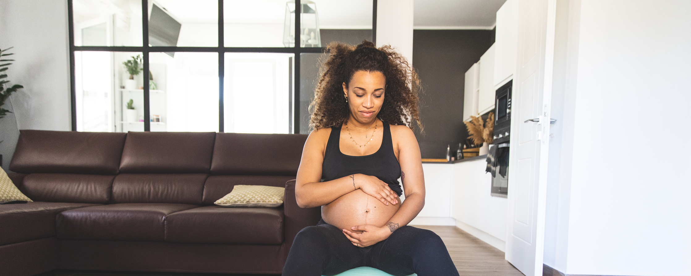 Pregnant woman sitting on a birthing ball