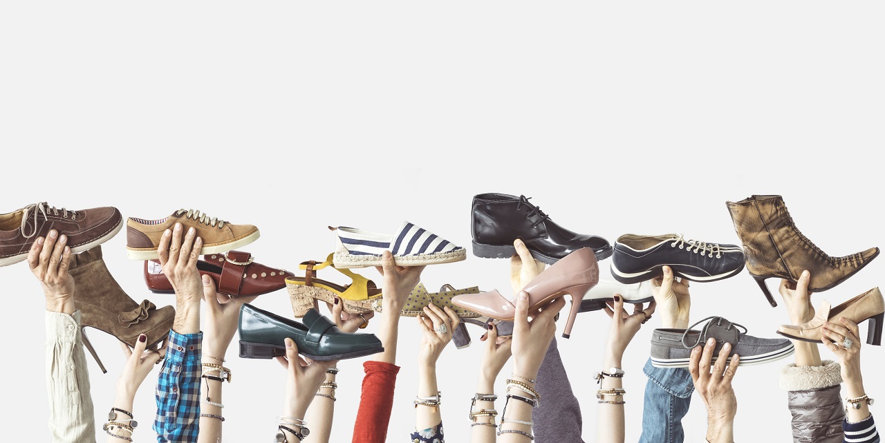 Image of people holding shoes in the air