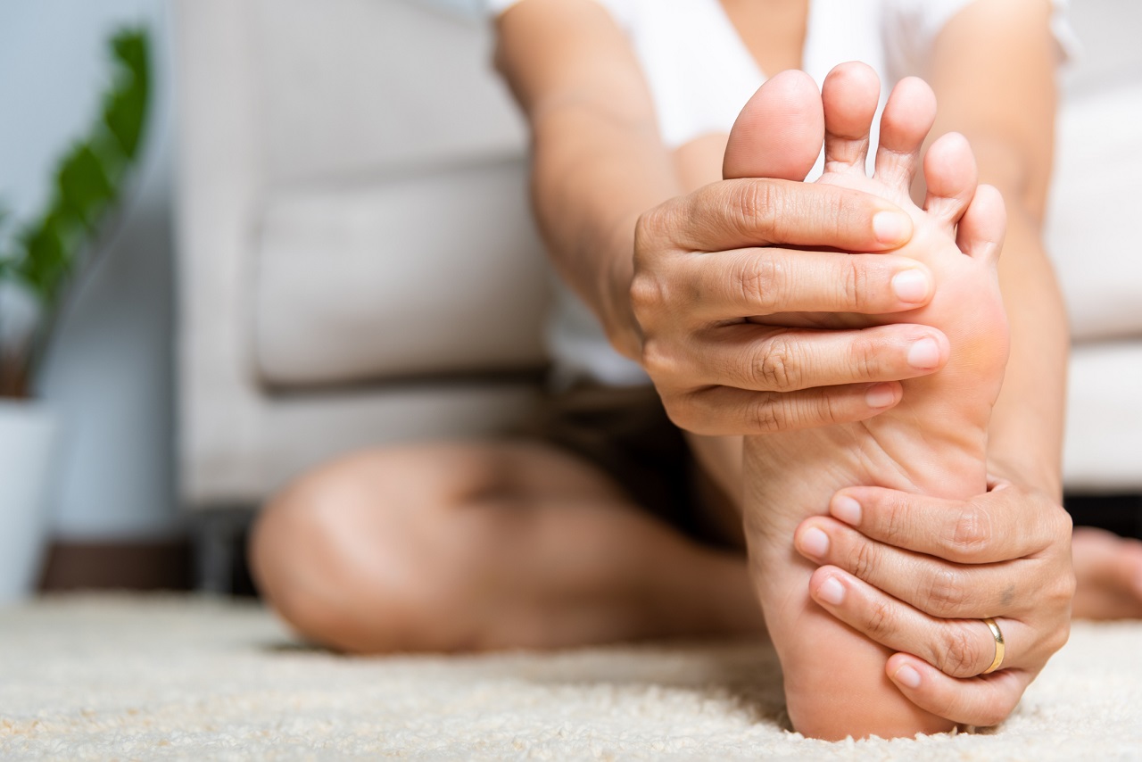 Woman holding her foot in pain