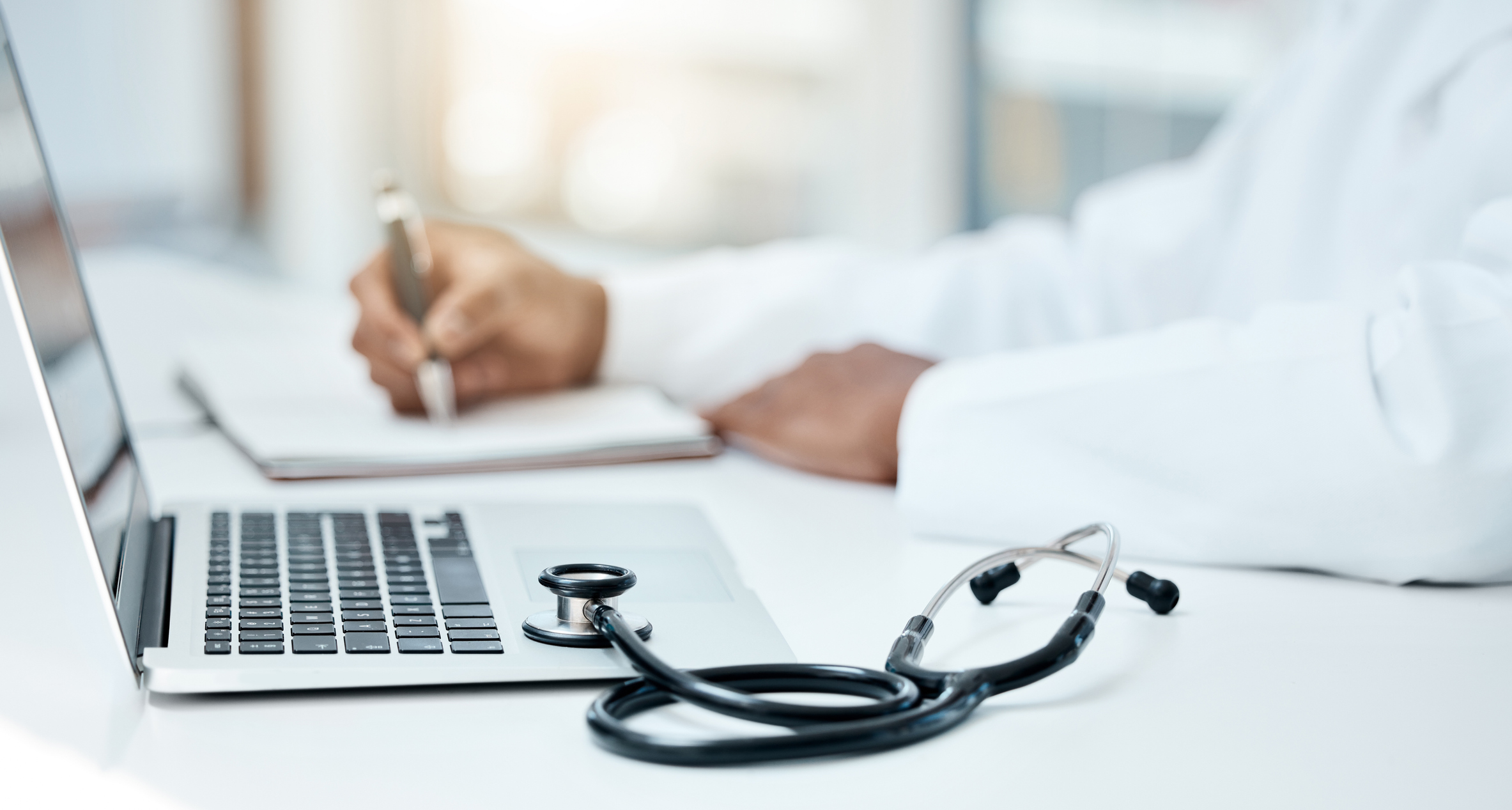 Doctor reviewing patient information on laptop