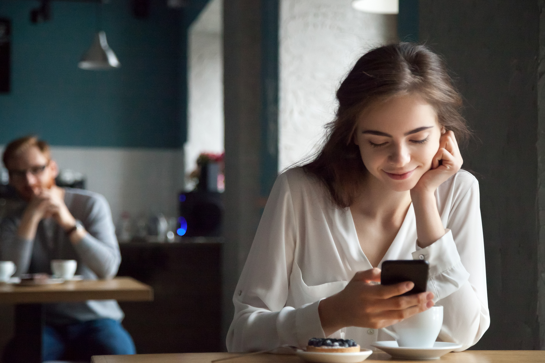 Woman using her phone in a public setting.