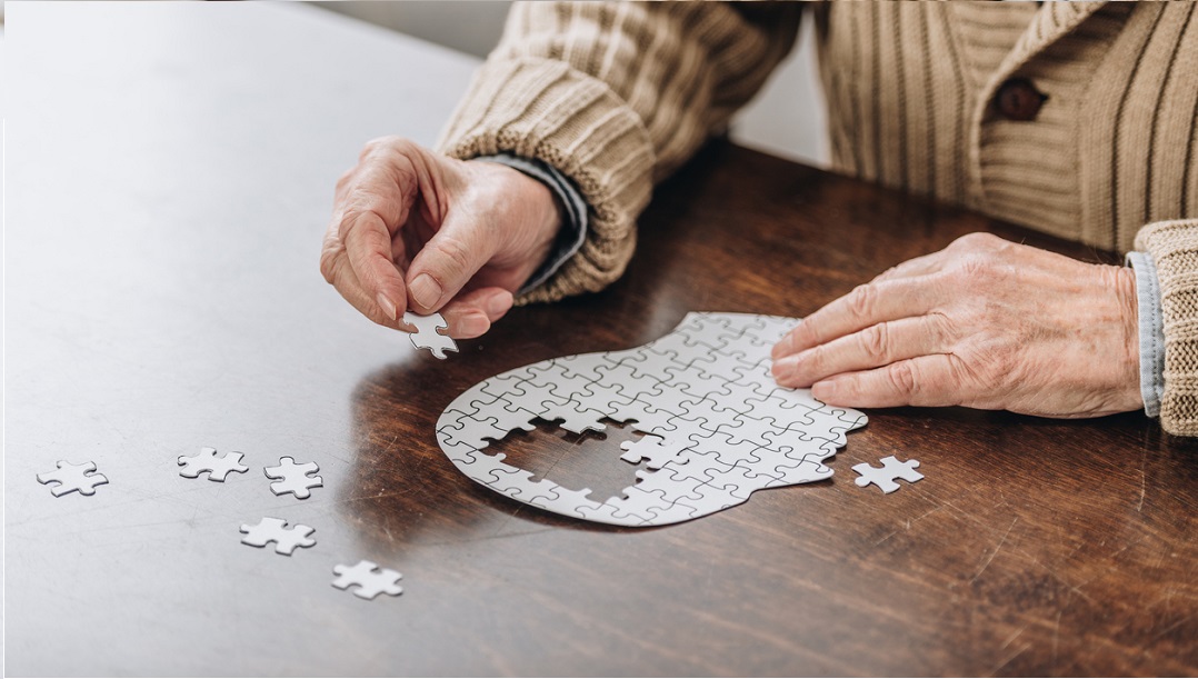 Old man completing puzzle 