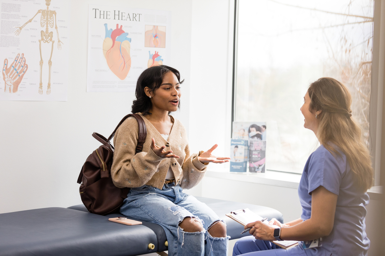 Teen girl consulting with doctor 