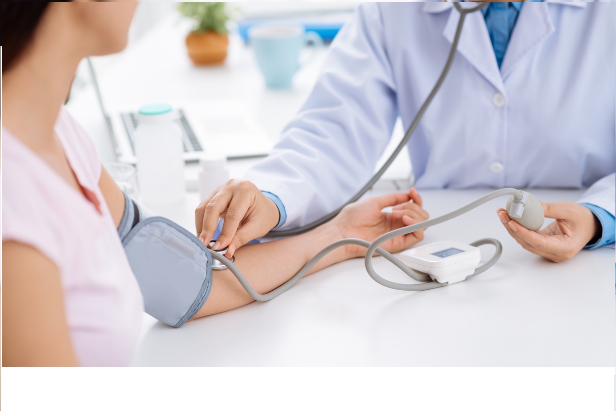 Doctor checking patient's blood pressure  