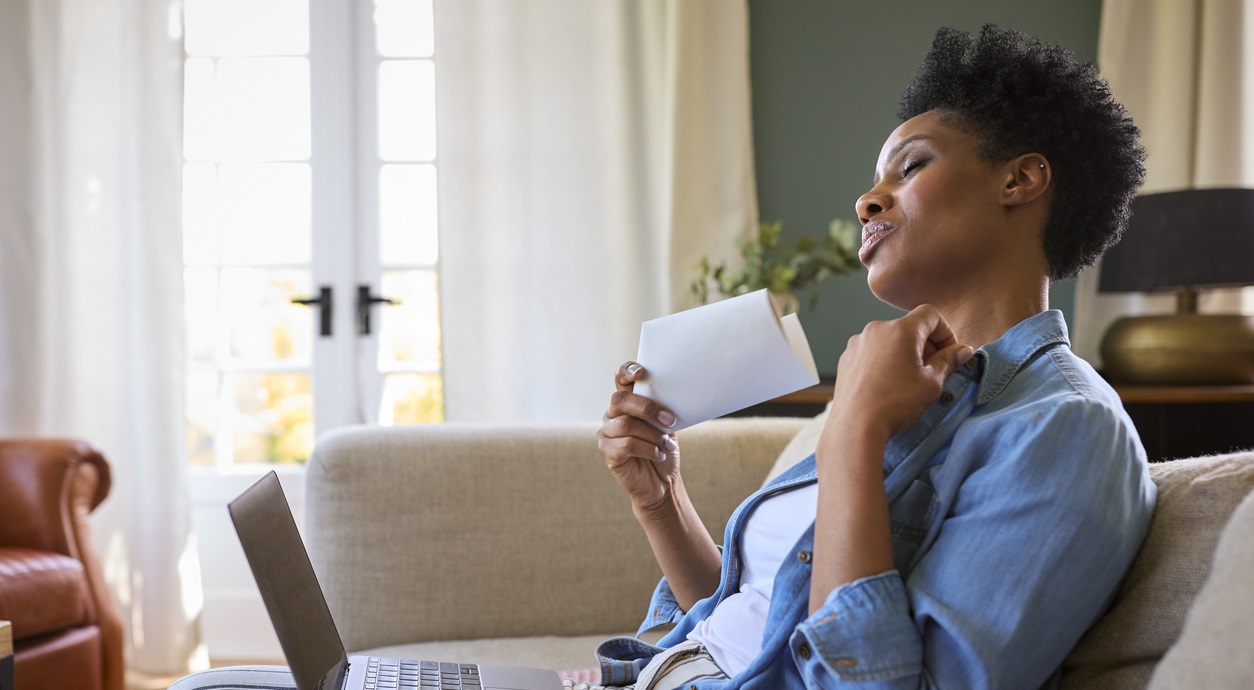 woman fanning herself with paper