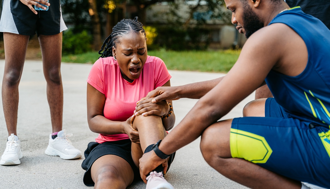 Sports therapist checking injured athlete 