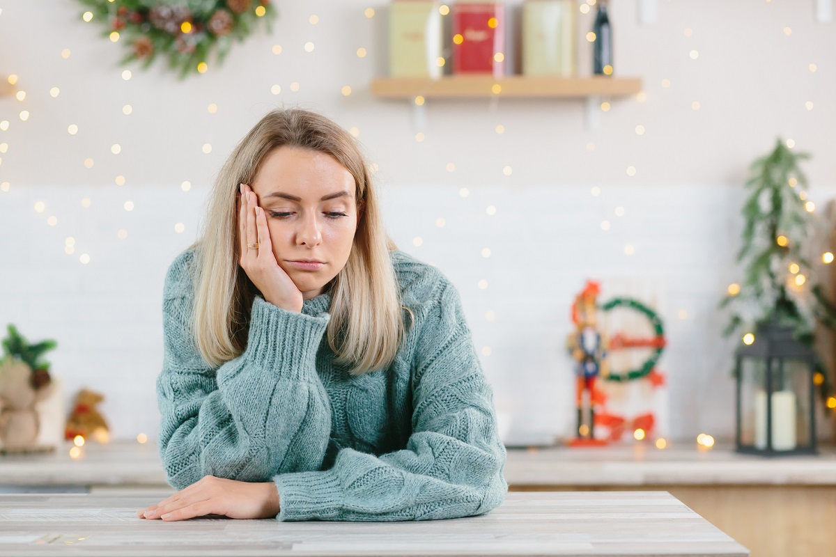 Woman thinking while decorating house for holiday season