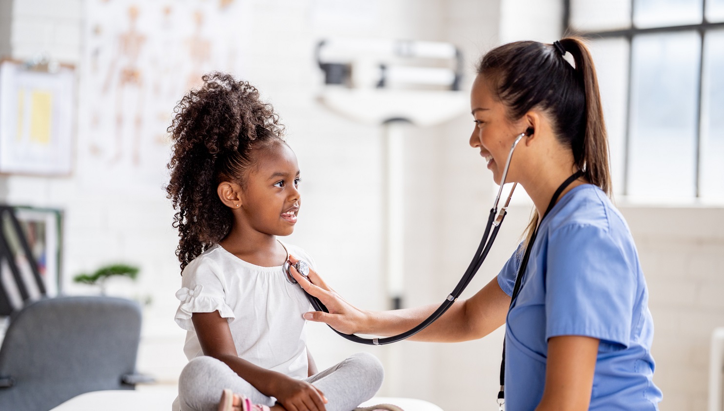 Pediatric doctor examining a young child