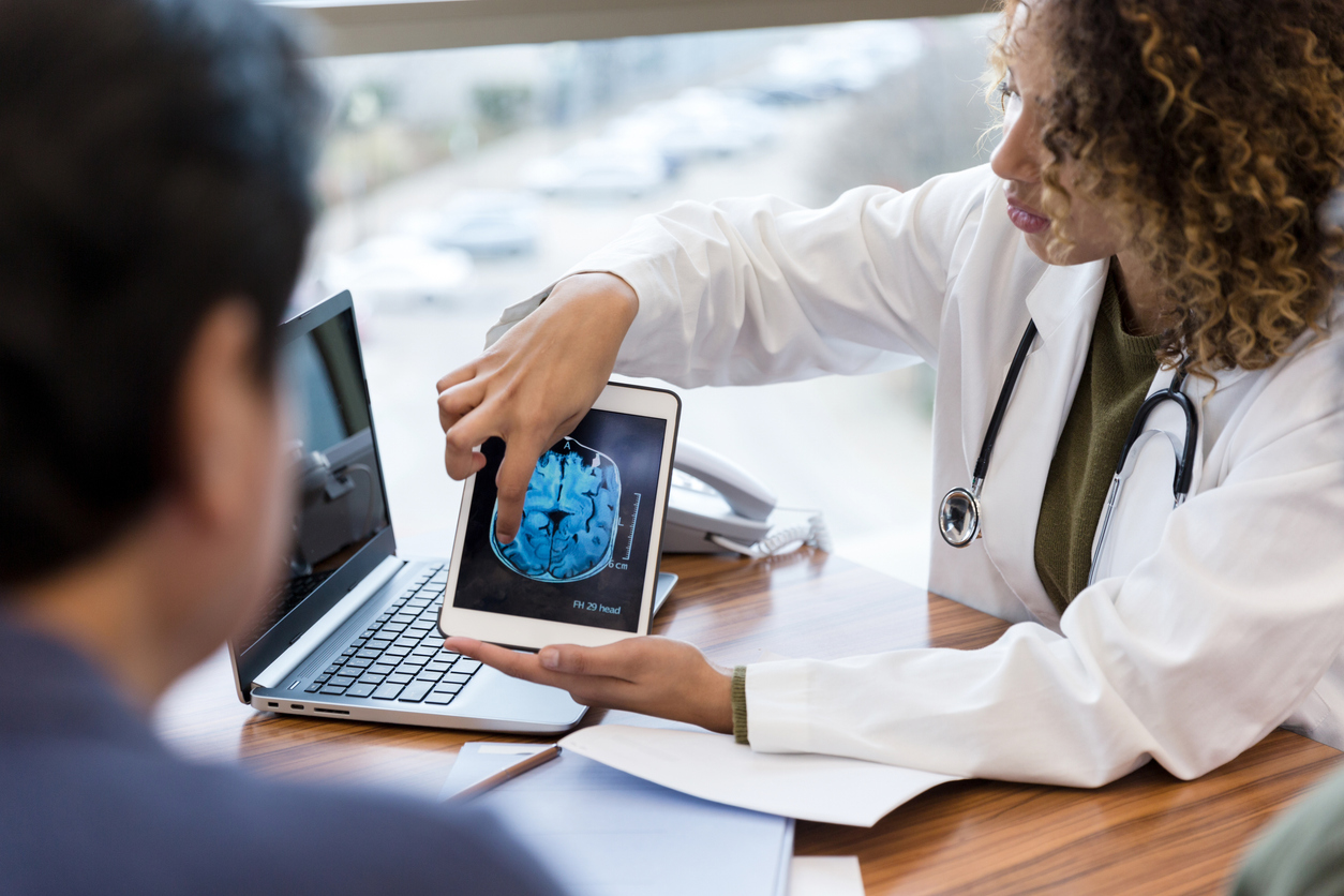 Doctor showing brain scan to patient