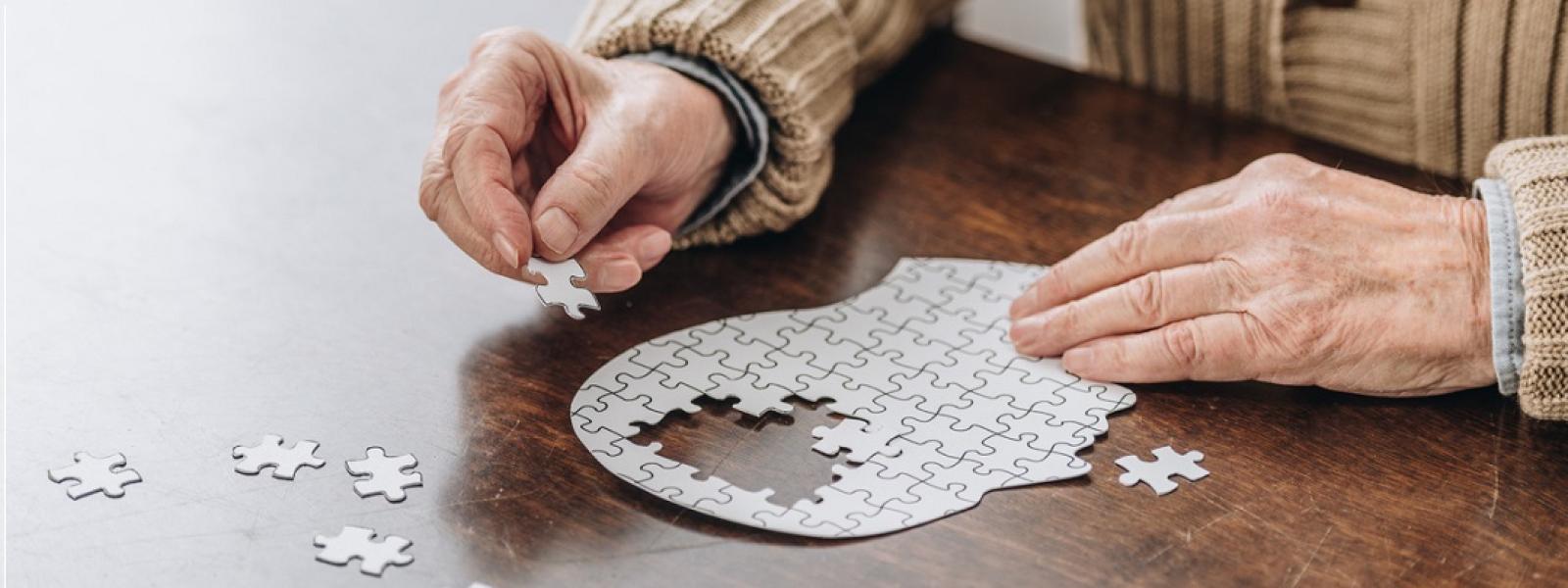 Old man completing puzzle 