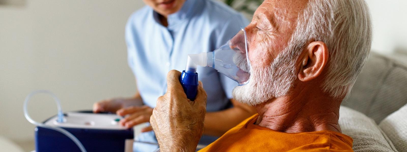 Old man taking oxygen therapy 