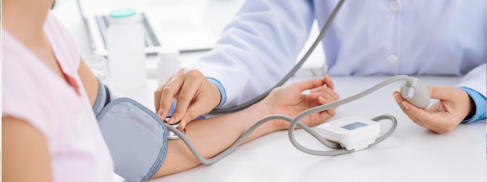 Doctor checking patient's blood pressure  