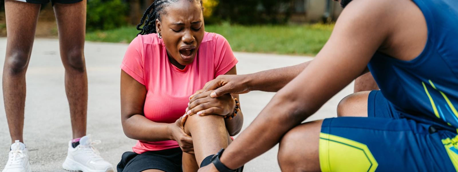 Sports therapist checking injured athlete 