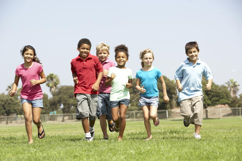 A group of children running in a field