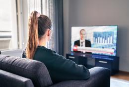 Young girl watching news on TV