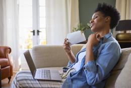 woman fanning herself with paper