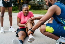 Sports therapist checking injured athlete 