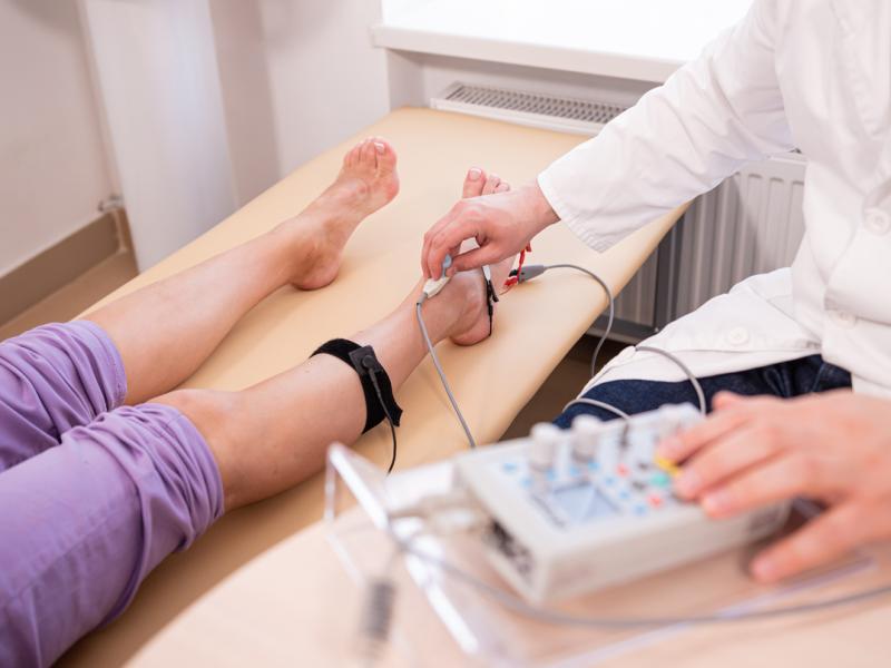 Doctor checking patients legs for any artery disease