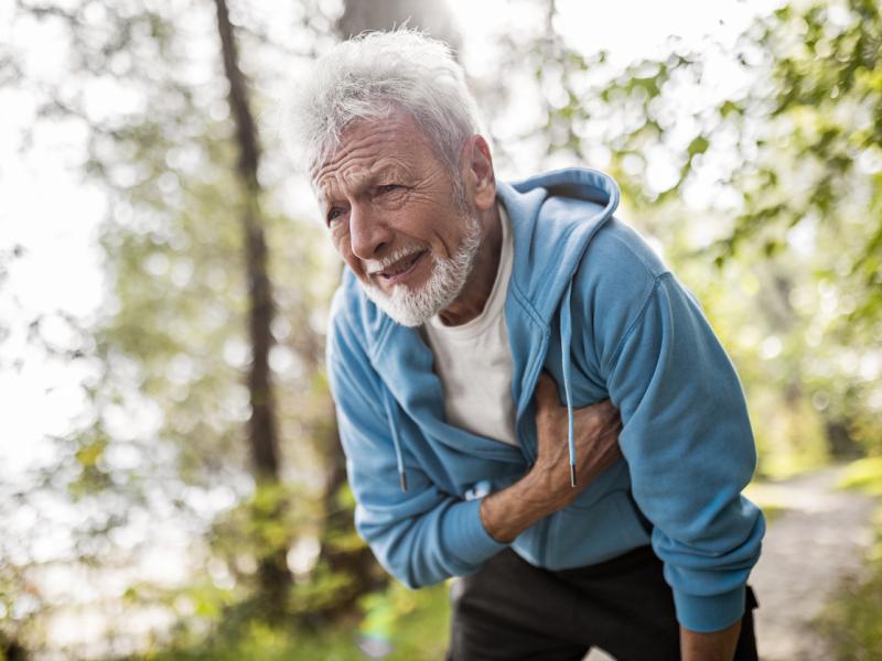 Old man holding his chest in pain 