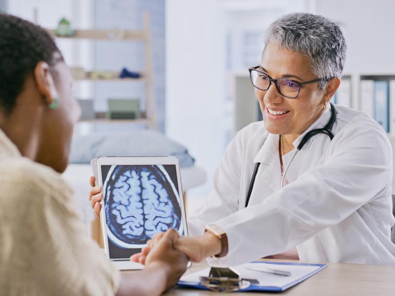 Doctor showing human brain scan to patient 