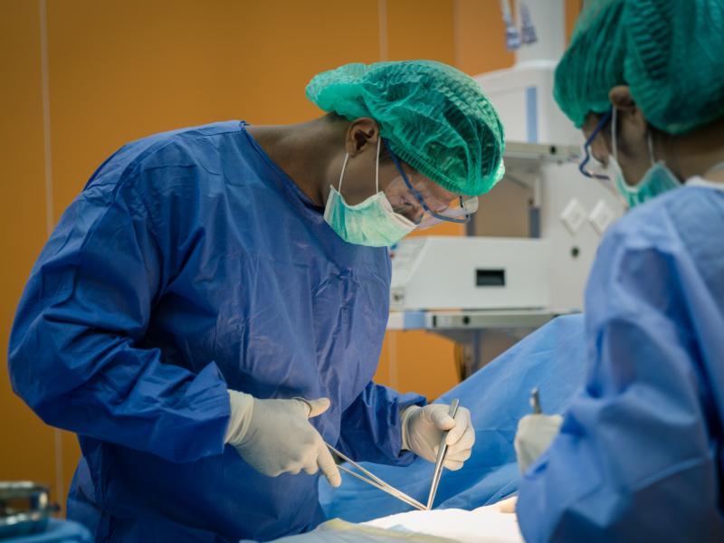 Two doctors doing general surgery in operation room