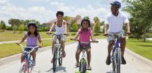 Black family riding bikes