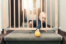 An Infant playing with ball near stairs 