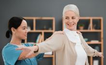 occupational therapist works with an elderly woman