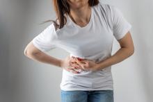 woman holding her tummy in pain