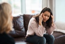 young woman stressing while talking to therapist