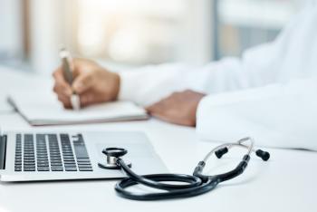 Doctor reviewing patient information on laptop