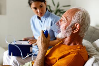 Old man taking oxygen therapy 