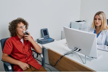 Young boy taking lung function test under doctor's supervision