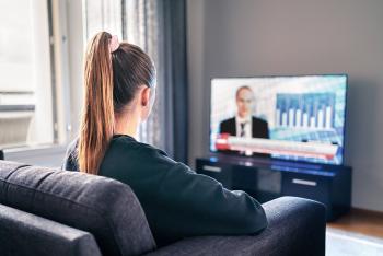 Young girl watching news on TV