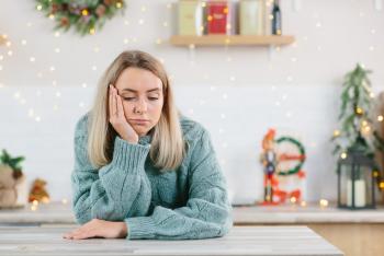 Woman thinking while decorating house for holiday season