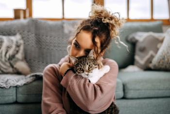 woman playing with her cat