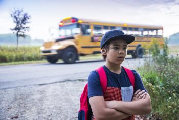 Kid facing opposite to school bus